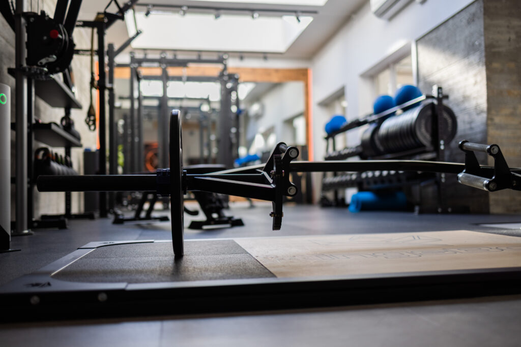 Krafttrainingsbereich im Edletics Studio mit Langhantel, Rack und Hantelscheiben
